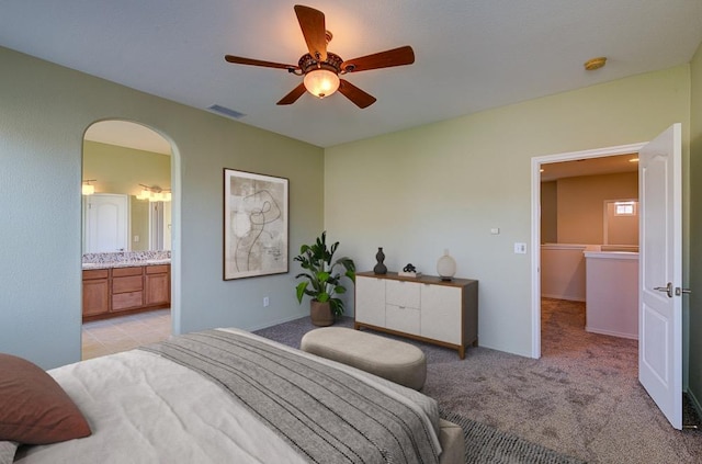 619 W Casanova Ln, Clovis, CA 93619 - bedroom featuring light carpet, arched walkways, a ceiling fan, and ensuite bathroom