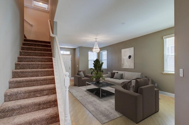 619 W Casanova Ln, Clovis, CA 93619 - living room with light wood-style floors, stairs, a chandelier, and baseboards