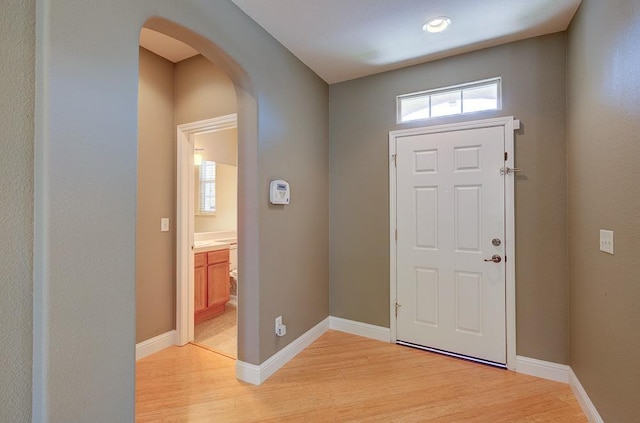 619 W Casanova Ln, Clovis, CA 93619 - foyer entrance with arched walkways, light wood-type flooring, and baseboards