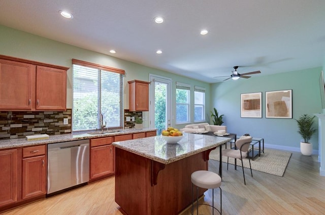 619 W Casanova Ln, Clovis, CA 93619 - kitchen with dishwasher, a sink, light wood-type flooring, backsplash, and a kitchen island
