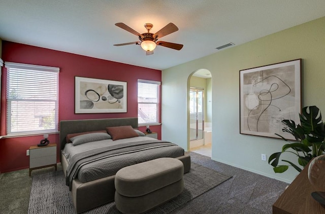 619 W Casanova Ln, Clovis, CA 93619 - carpeted bedroom with arched walkways, multiple windows, ensuite bathroom, and a ceiling fan