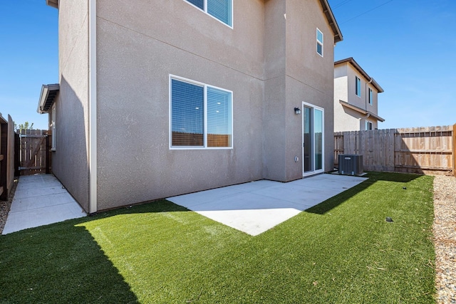 6260 E Malbec Dr, Fresno, CA 93727 - rear view of property featuring a lawn, central air condition unit, a fenced backyard, a patio, and stucco siding