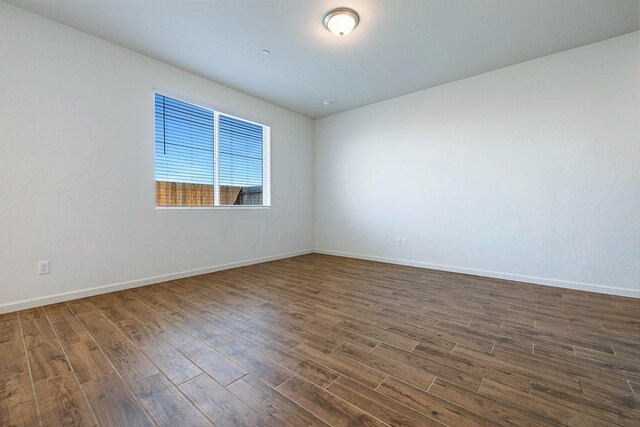 6260 E Malbec Dr, Fresno, CA 93727 - empty room with baseboards and dark wood finished floors