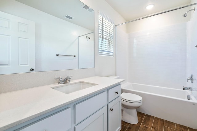 6260 E Malbec Dr, Fresno, CA 93727 - bathroom featuring visible vents, wood finish floors, vanity, toilet, and washtub / shower combination