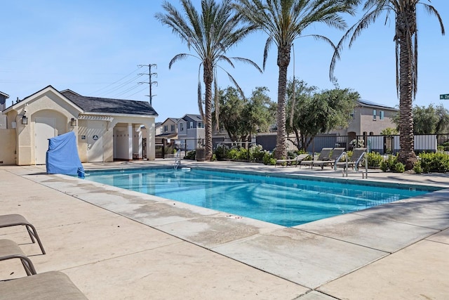 6260 E Malbec Dr, Fresno, CA 93727 - pool featuring a patio area, fence, and a residential view