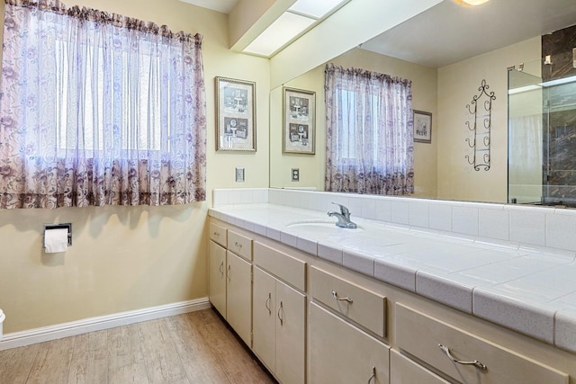 6154 E Alta Ave, Fresno, CA 93727 - full bath featuring baseboards, a shower with door, vanity, and wood finished floors