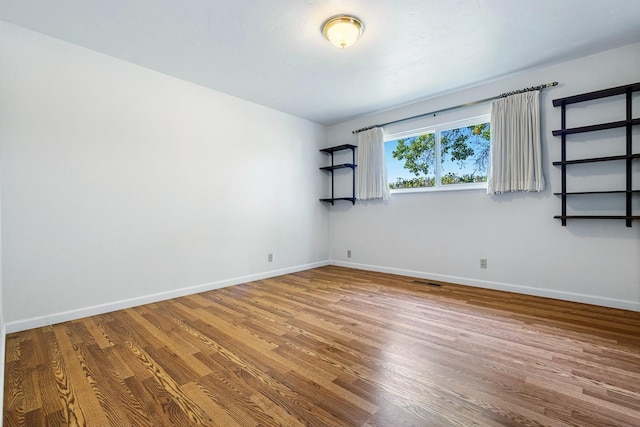 6154 E Alta Ave, Fresno, CA 93727 - spare room featuring baseboards, wood finished floors, and visible vents