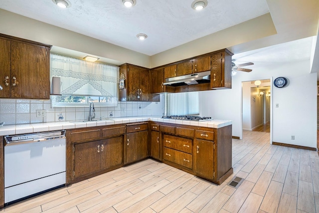6154 E Alta Ave, Fresno, CA 93727 - kitchen with white dishwasher, light wood-style flooring, a sink, and gas stovetop