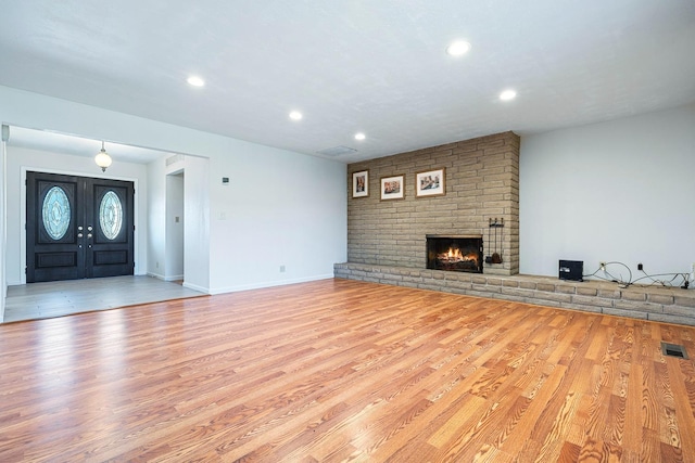6154 E Alta Ave, Fresno, CA 93727 - unfurnished living room featuring recessed lighting, visible vents, wood finished floors, and a fireplace