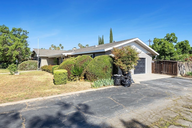 6154 E Alta Ave, Fresno, CA 93727 - ranch-style home featuring aphalt driveway, fence, a front lawn, and a garage