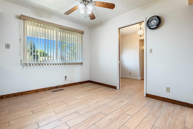 6154 E Alta Ave, Fresno, CA 93727 - spare room featuring a ceiling fan, baseboards, visible vents, and light wood finished floors