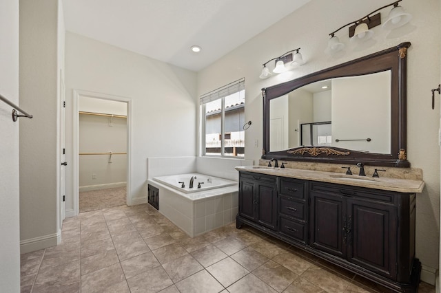 5534 N La Ventana Ave, Fresno, CA 93723 - full bath with double vanity, a walk in closet, a sink, and a bath