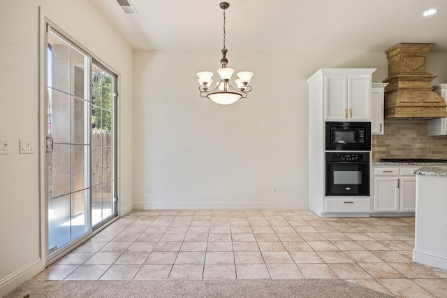 5534 N La Ventana Ave, Fresno, CA 93723 - kitchen with visible vents, tasteful backsplash, black appliances, an inviting chandelier, and custom range hood