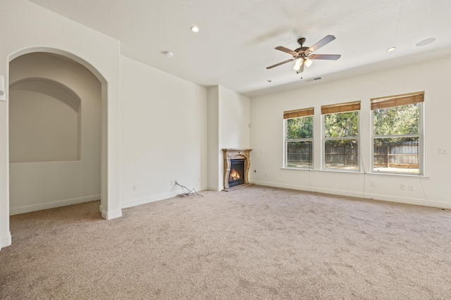 5534 N La Ventana Ave, Fresno, CA 93723 - unfurnished living room with carpet flooring, a ceiling fan, a warm lit fireplace, and baseboards