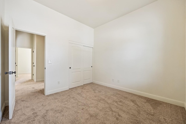 5534 N La Ventana Ave, Fresno, CA 93723 - unfurnished bedroom with baseboards, a closet, vaulted ceiling, and light carpet