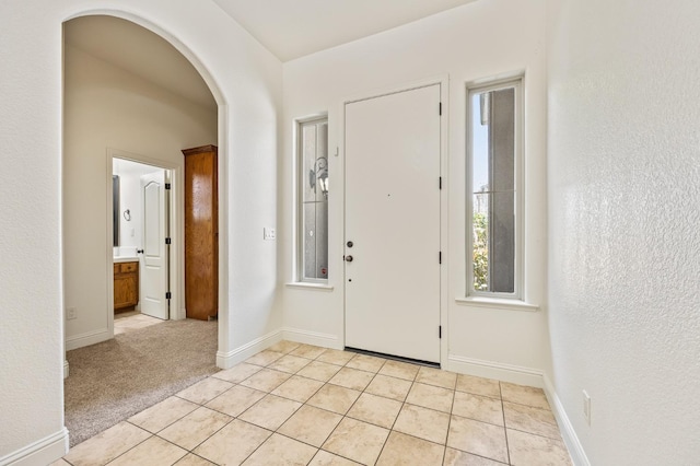 5534 N La Ventana Ave, Fresno, CA 93723 - entrance foyer with arched walkways, baseboards, and light tile patterned flooring