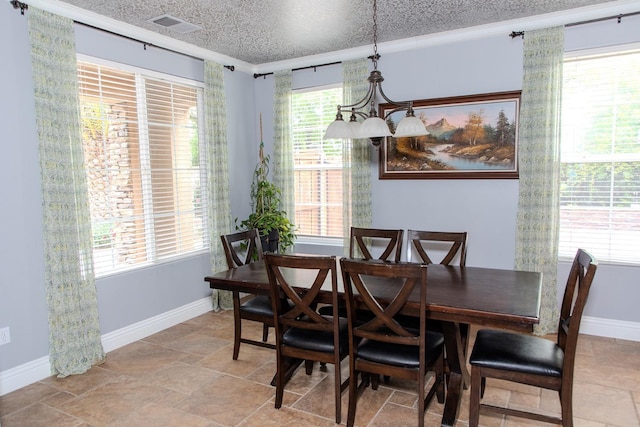 3107 Indianapolis Ave, Clovis, CA 93619 - dining space featuring light stone finish floors and ornamental molding