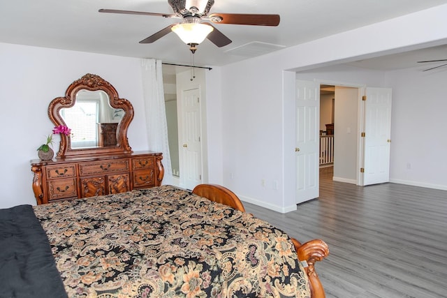 bedroom with ceiling fan, baseboards, visible vents, and wood finished floors