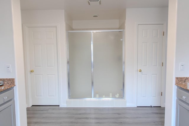 3107 Indianapolis Ave, Clovis, CA 93619 - full bathroom featuring vanity, a shower stall, and wood finished floors