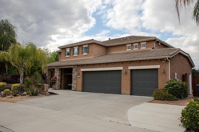 3107 Indianapolis Ave, Clovis, CA 93619 - view of front of house featuring an attached garage, concrete driveway, stucco siding, and a tiled roof