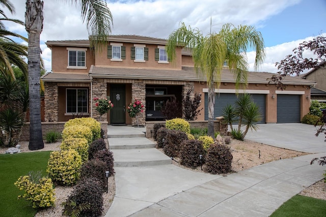 view of front of property with a garage, covered porch, stone siding, stucco siding, and driveway