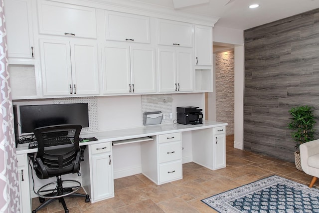 office area featuring built in study area, baseboards, recessed lighting, and stone finish flooring