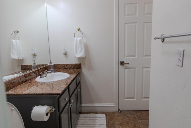 bathroom with vanity and baseboards