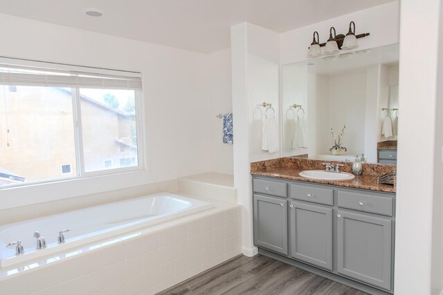 3107 Indianapolis Ave, Clovis, CA 93619 - full bath featuring vanity, a garden tub, and wood finished floors
