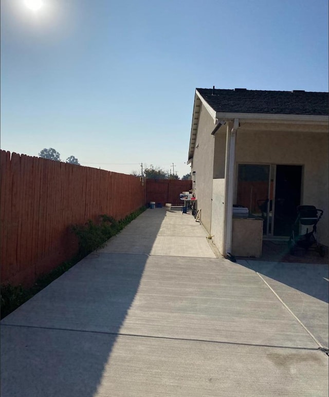 5244 W Fern Ave, Fresno, CA 93722 - view of side of home with a fenced backyard and stucco siding