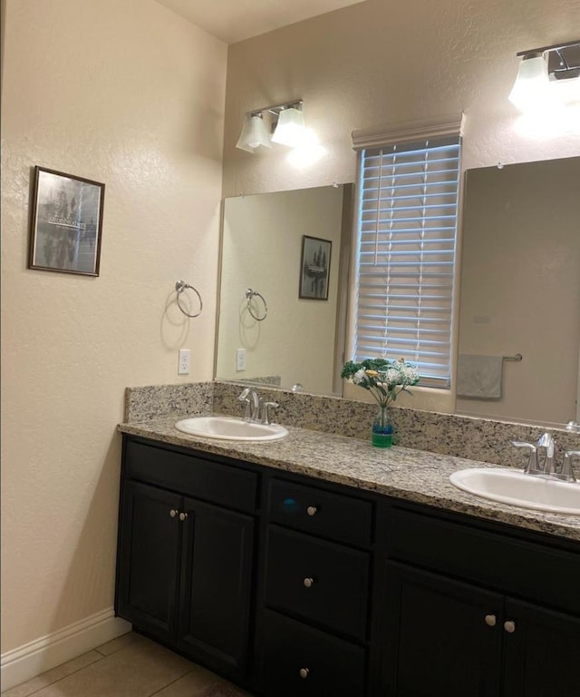 5244 W Fern Ave, Fresno, CA 93722 - full bath with double vanity, a sink, and tile patterned floors