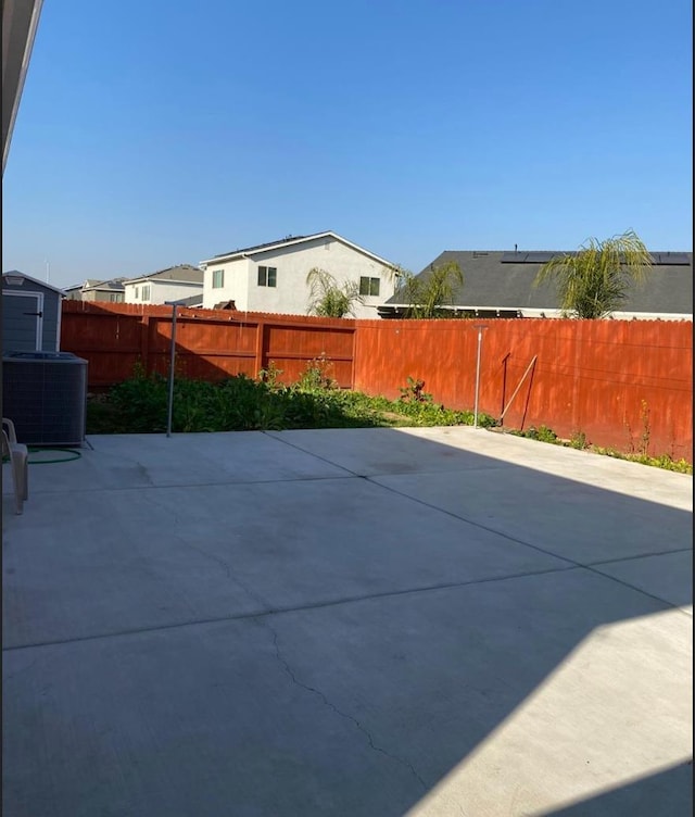 5244 W Fern Ave, Fresno, CA 93722 - view of patio / terrace with a fenced backyard and cooling unit