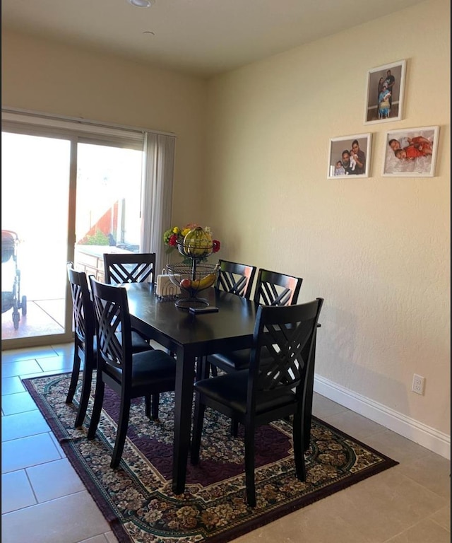 5244 W Fern Ave, Fresno, CA 93722 - dining area with baseboards and tile patterned flooring