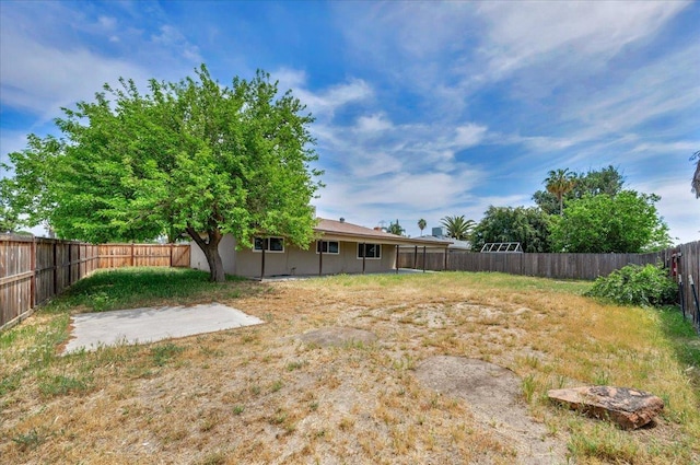 view of yard with a fenced backyard and a patio area