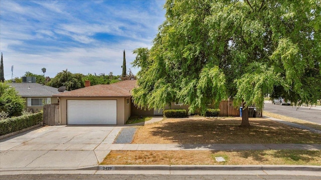 view of front of property with a garage, stucco siding, a chimney, and concrete driveway