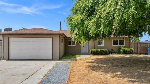 ranch-style house with stucco siding, a garage, fence, and concrete driveway
