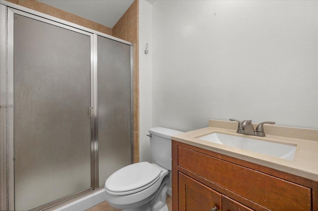 bathroom featuring vanity, a stall shower, and toilet