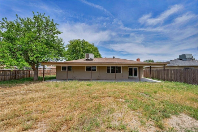 back of house featuring a fenced backyard, a patio, a yard, and central air condition unit