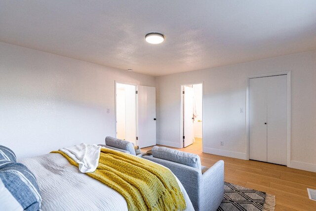 bedroom featuring baseboards and light wood-style flooring
