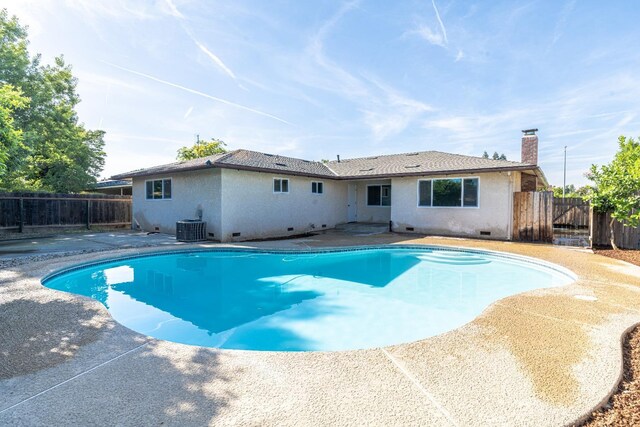 view of pool with a fenced backyard, a fenced in pool, central AC unit, and a patio