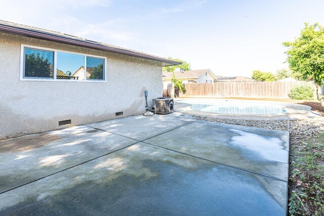 exterior space with a fenced backyard, a fenced in pool, central AC, and a patio