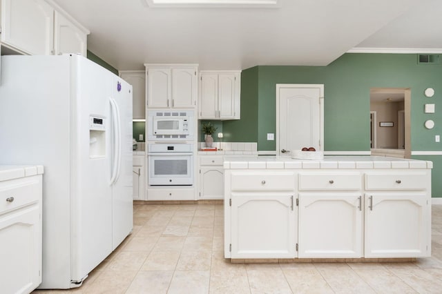 kitchen with visible vents, tile countertops, white cabinets, and white appliances