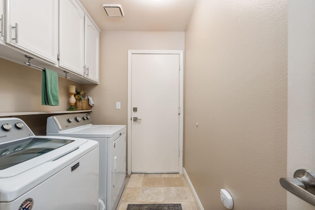 laundry room with baseboards, cabinet space, and independent washer and dryer