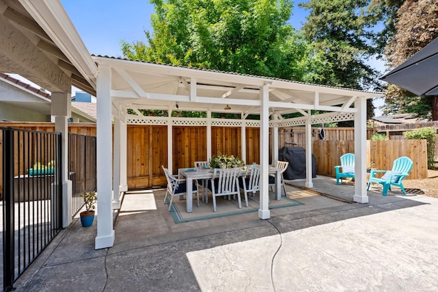 view of patio / terrace with a gazebo, fence, and outdoor dining space
