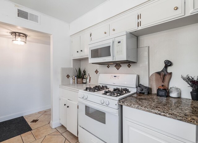 927 W Pico, Clovis, CA 93612 - kitchen with visible vents, white appliances, white cabinetry, tasteful backsplash, and light tile patterned floors