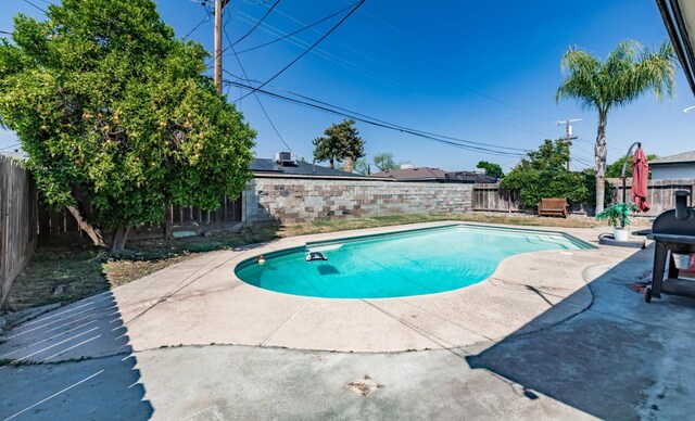 927 W Pico, Clovis, CA 93612 - view of swimming pool featuring a fenced backyard, a fenced in pool, a patio, and area for grilling