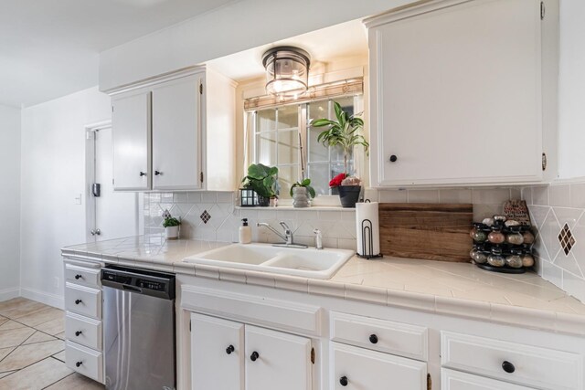 927 W Pico, Clovis, CA 93612 - kitchen featuring stainless steel dishwasher, white cabinetry, decorative backsplash, and a sink