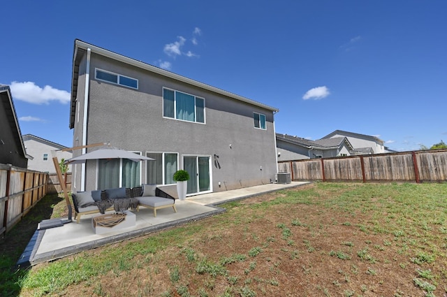 rear view of property featuring a patio area, stucco siding, a fenced backyard, and an outdoor living space