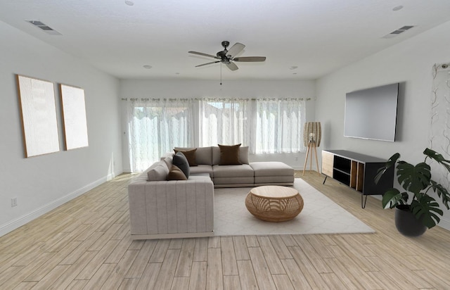 living room with visible vents, plenty of natural light, and wood finished floors