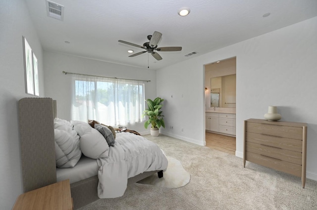 bedroom with light colored carpet, baseboards, and visible vents