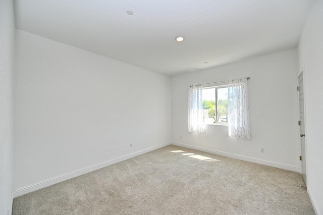 carpeted spare room with baseboards and recessed lighting